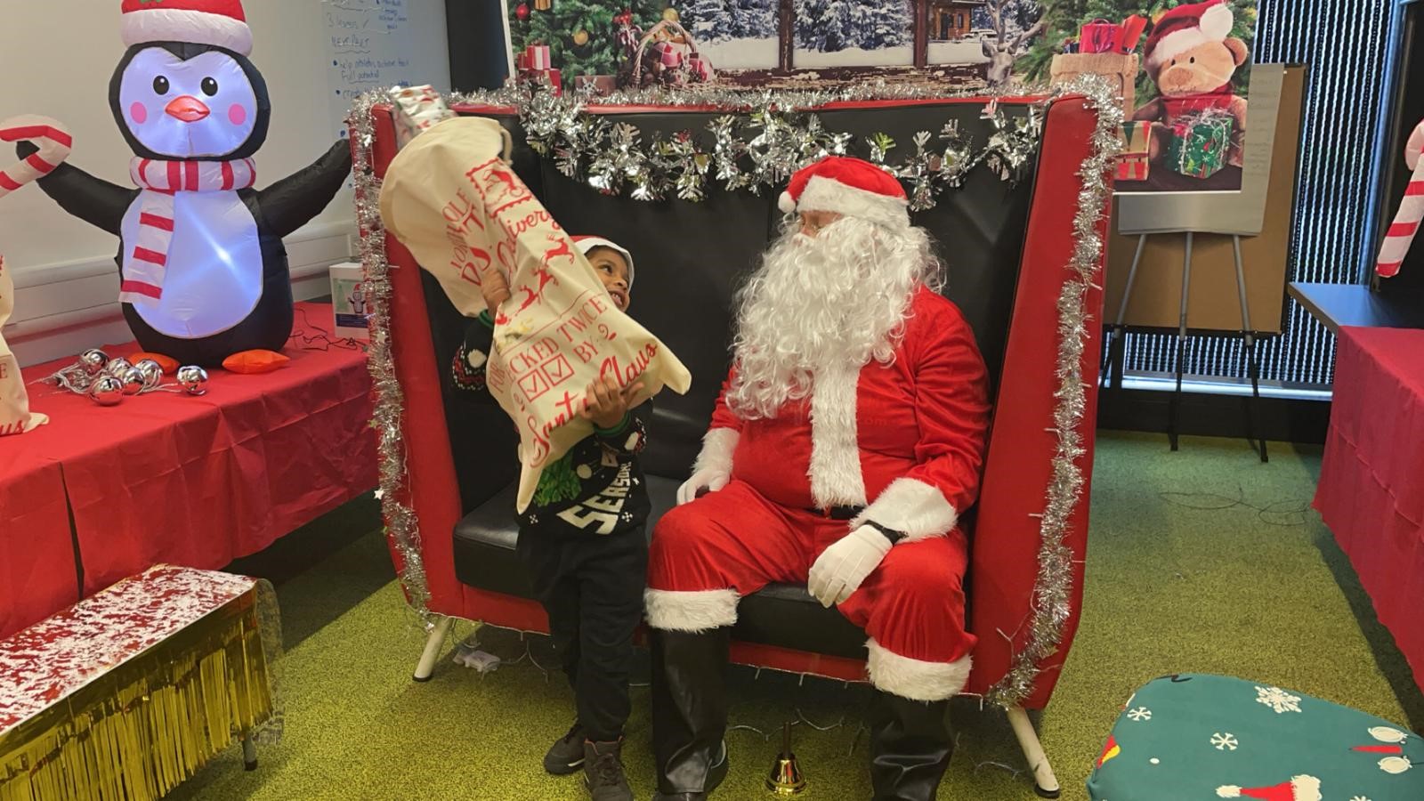 Santa Claus handing out gifts at our Christmas Day celebration