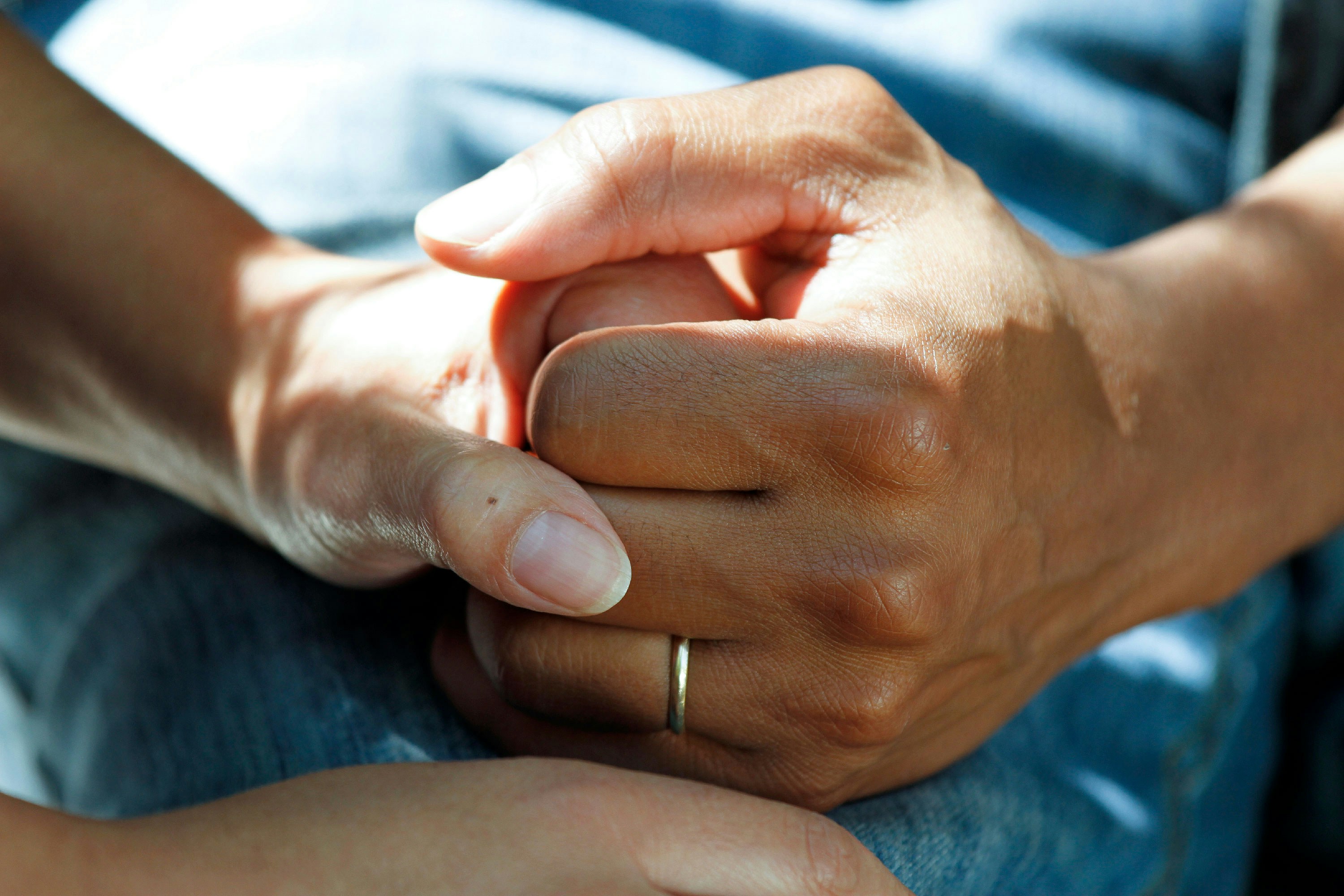 A patient holding hands with a nurse